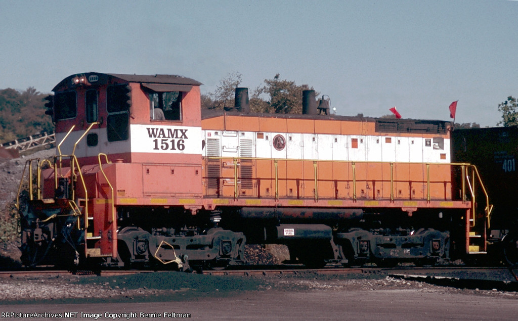 Jefferson Warrior Railroad WAMX SW1500 #1516, flying red flags on the "F" end, switching coal loads 